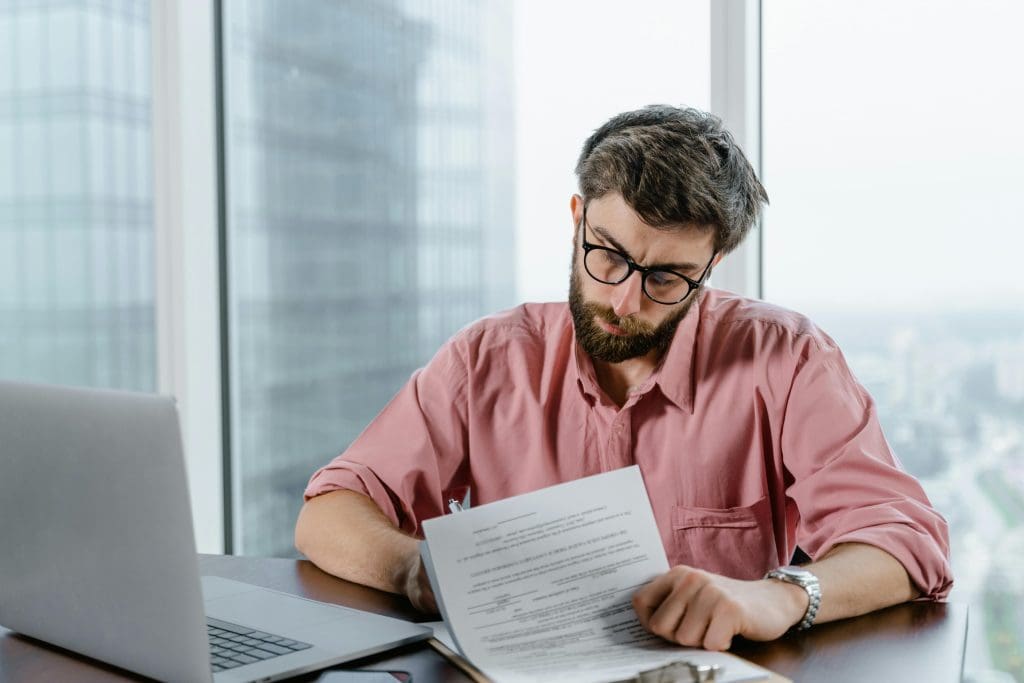 Person reviewing documents at desk.
