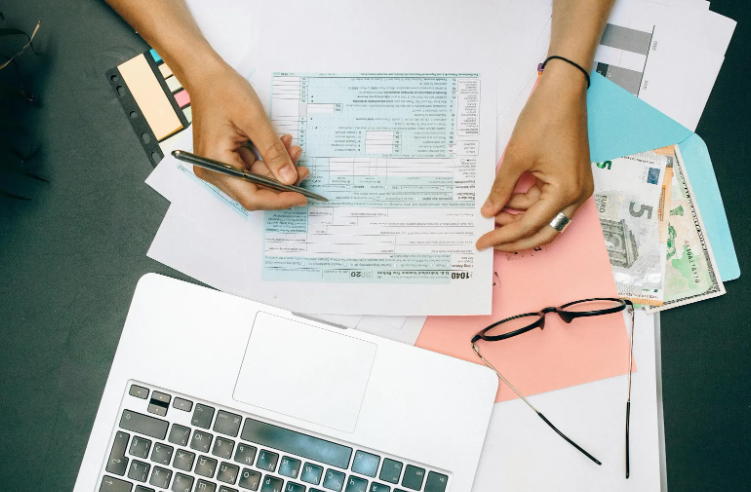 Hands filling out tax forms